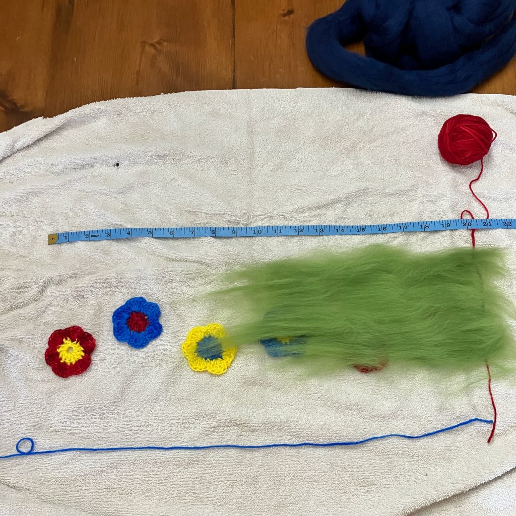 Prepping wet felting design with dry fibre and embellishments