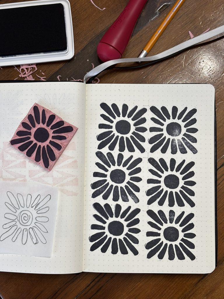 Playing with carving, inking and printing 2x2 inch linocut stamps. This one is a flower.