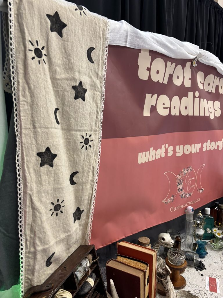 alchemist-themed tarot reading booth for a pop up renaissance fair with hand-stamped mystic drapes with suns, moons and stars